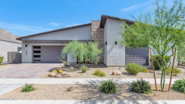 812 E Summerside Rd, Phoenix, AZ 85042 - contemporary home featuring an attached garage, driveway, and stucco siding