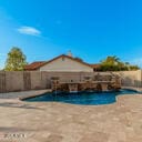 view of swimming pool featuring a fenced in pool, a fenced backyard, and a patio area