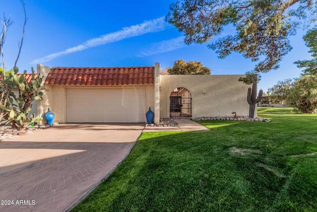 view of front of home featuring a garage and a front lawn