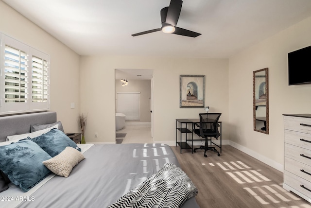 bedroom with connected bathroom, ceiling fan, and hardwood / wood-style floors