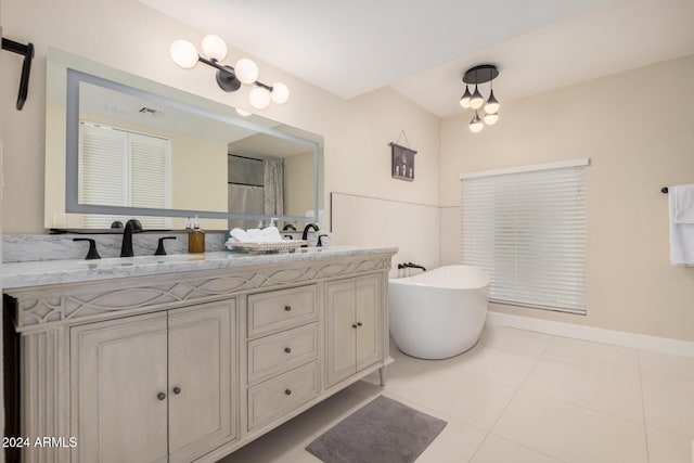 bathroom with tile patterned floors, vanity, and a tub to relax in