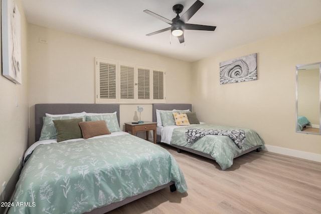 bedroom with light wood-type flooring and ceiling fan