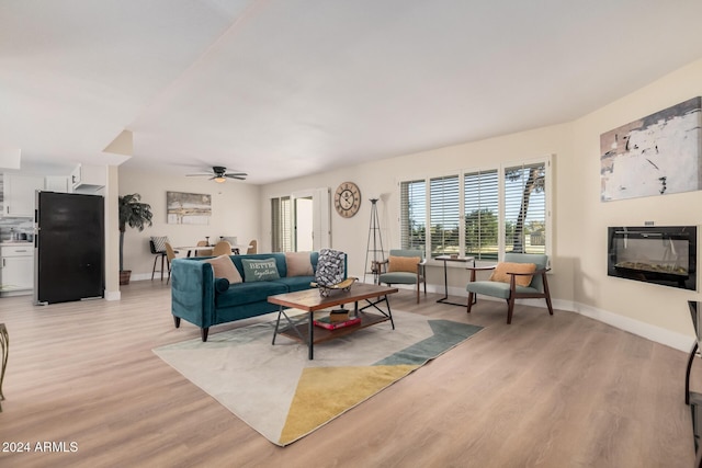 living room with ceiling fan and light wood-type flooring