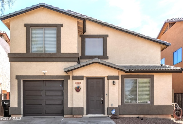view of front facade featuring a garage and stucco siding