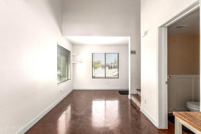 interior space featuring concrete flooring and baseboards