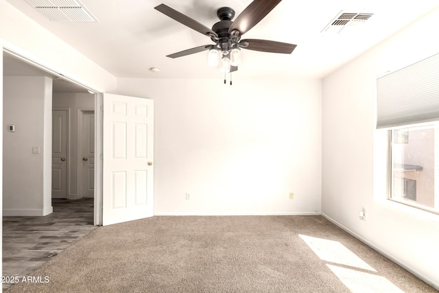 interior space with visible vents, baseboards, and ceiling fan