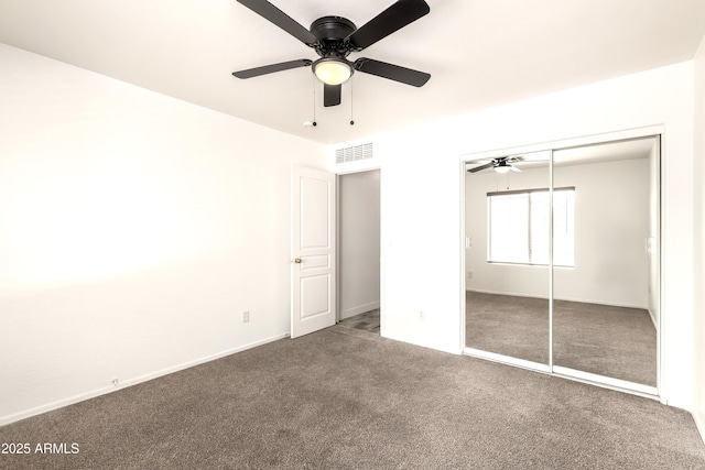 unfurnished bedroom with a ceiling fan, visible vents, carpet, and a closet