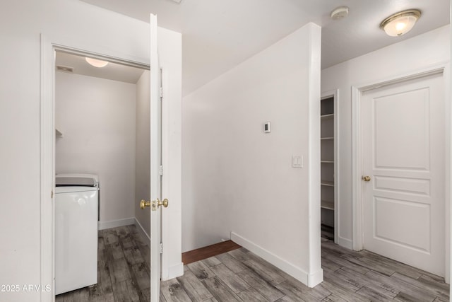 laundry room featuring washer / dryer, baseboards, laundry area, and wood finished floors