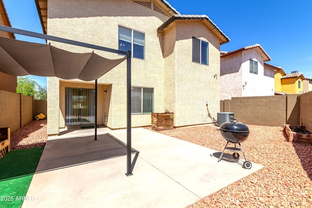 back of house with a patio, cooling unit, a fenced backyard, and stucco siding