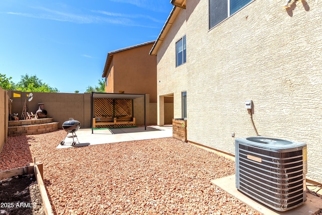 view of yard with a patio area, central AC, and fence