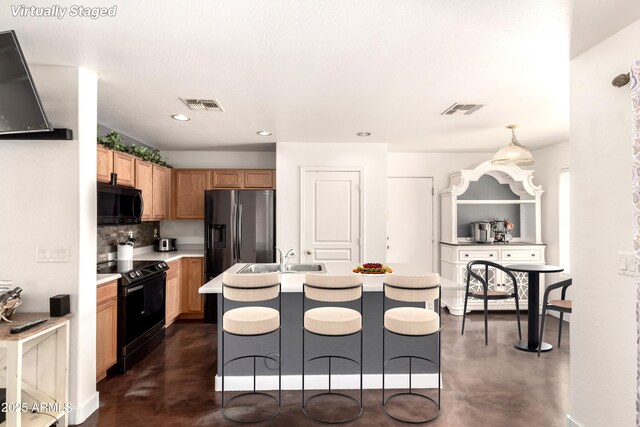 kitchen featuring visible vents, a sink, concrete flooring, and black appliances