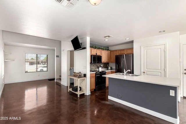 kitchen with decorative backsplash, visible vents, light countertops, black appliances, and concrete floors
