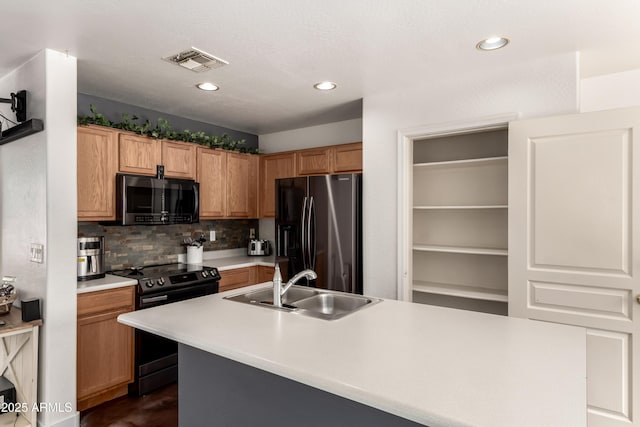 kitchen featuring range with electric stovetop, visible vents, a sink, fridge with ice dispenser, and stainless steel microwave