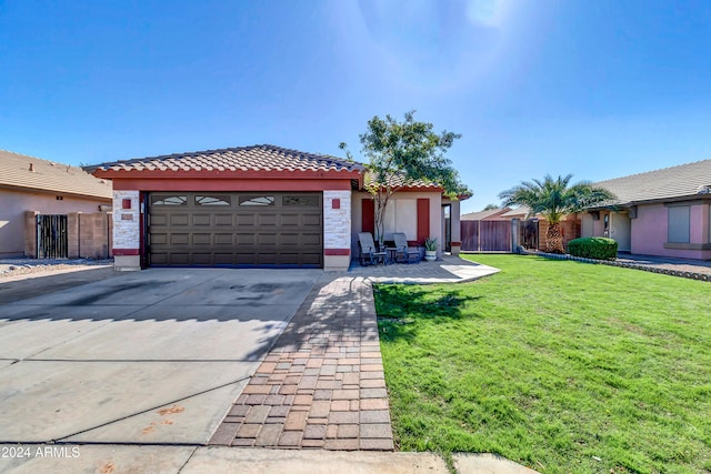 view of front of home featuring a patio area, a front yard, and a garage