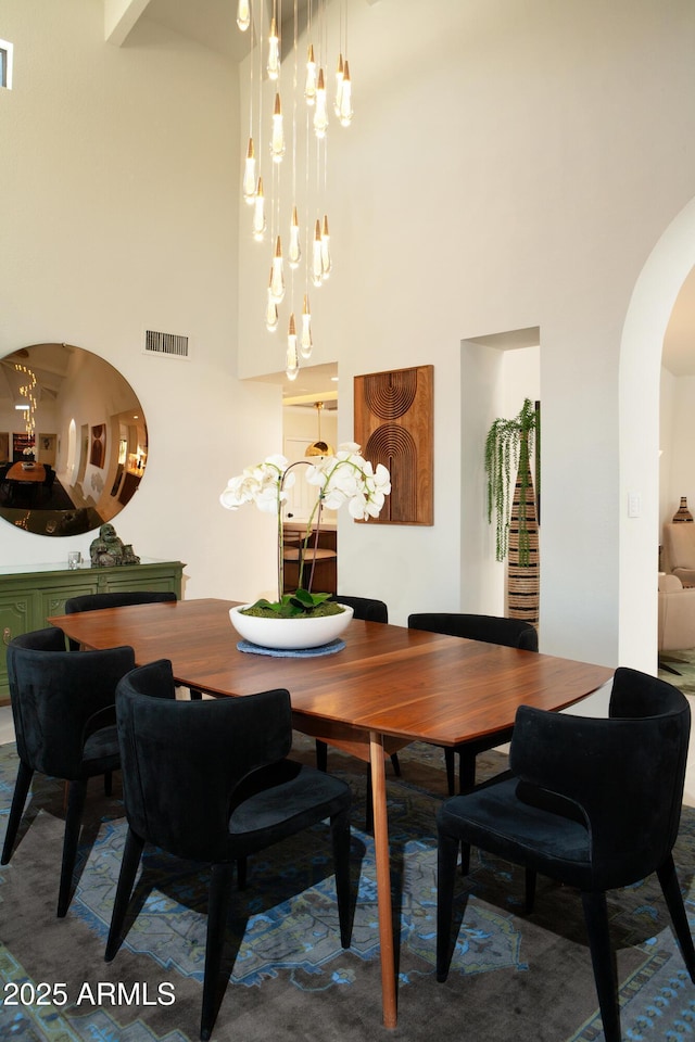 8332 E San Simon Dr, Scottsdale, AZ 85258 - dining area featuring a chandelier, visible vents, arched walkways, and a high ceiling