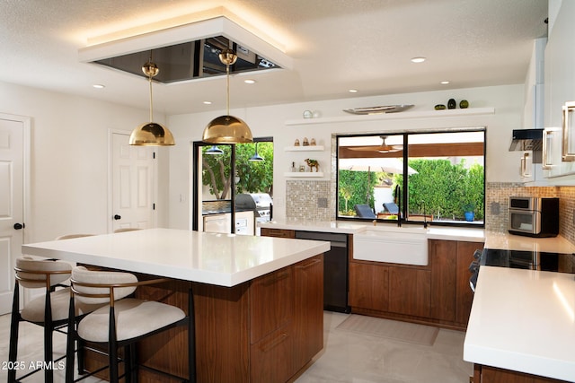 8332 E San Simon Dr, Scottsdale, AZ 85258 - kitchen featuring light countertops, a kitchen breakfast bar, black dishwasher, and decorative backsplash