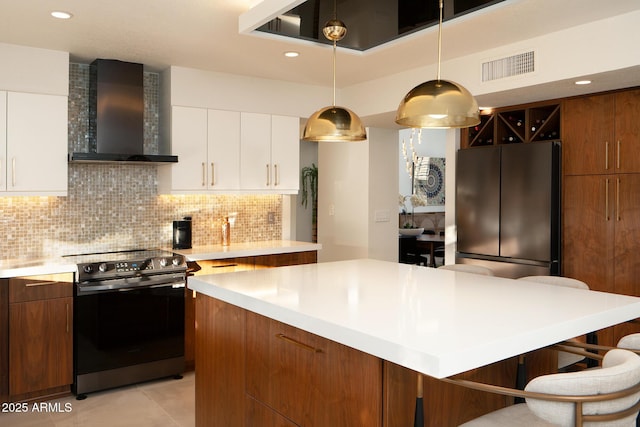 8332 E San Simon Dr, Scottsdale, AZ 85258 - kitchen with wall chimney range hood, light countertops, visible vents, stainless steel range with electric cooktop, and fridge