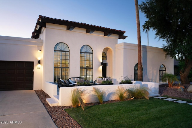 8332 E San Simon Dr, Scottsdale, AZ 85258 - mediterranean / spanish house featuring stucco siding, an attached garage, and driveway