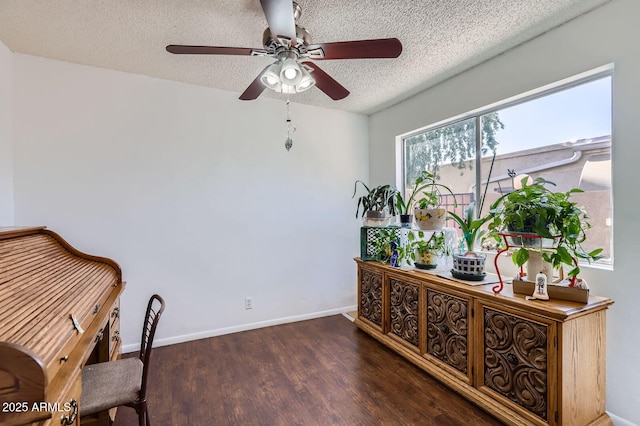 office featuring ceiling fan, a textured ceiling, baseboards, and wood finished floors