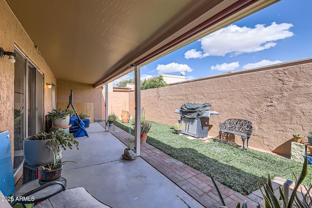 view of patio / terrace featuring fence and grilling area