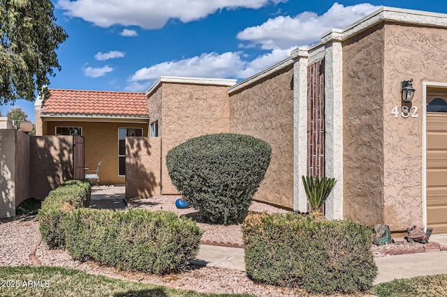 view of front of house featuring a tile roof and stucco siding