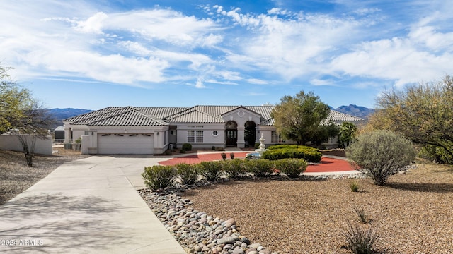 view of front of home with a mountain view and a garage