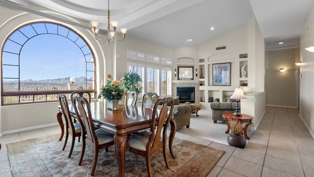 tiled dining room with a notable chandelier and a tile fireplace