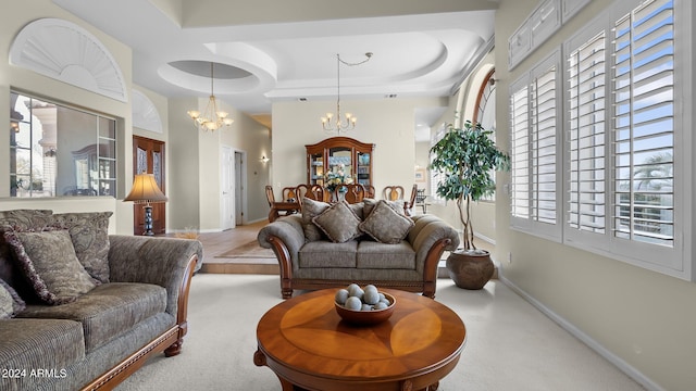 living room with light colored carpet, an inviting chandelier, and a wealth of natural light