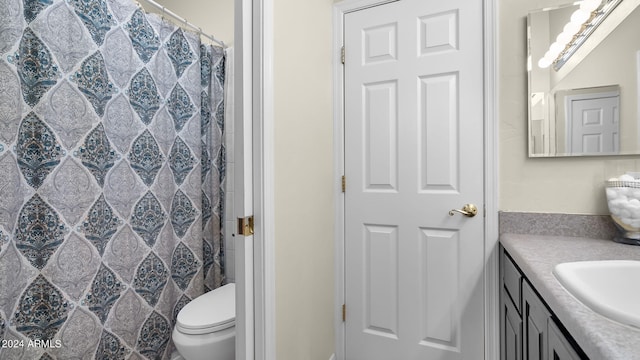 bathroom featuring vanity, toilet, and a shower with shower curtain