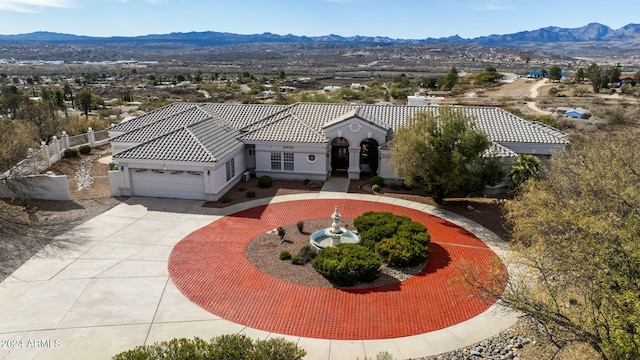 birds eye view of property featuring a mountain view