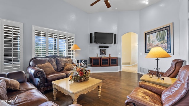 living room featuring ceiling fan, hardwood / wood-style floors, and high vaulted ceiling