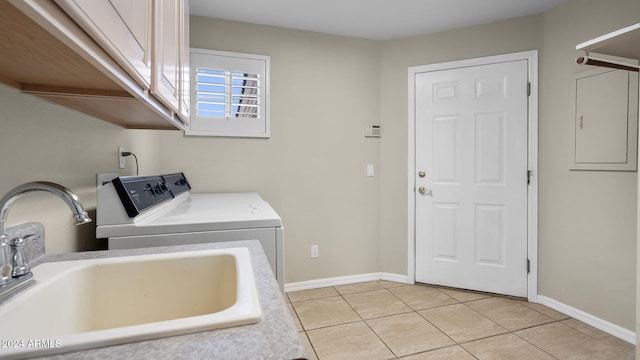 laundry area featuring cabinets, sink, washing machine and clothes dryer, and light tile patterned flooring