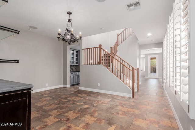 interior space with visible vents, recessed lighting, baseboards, a chandelier, and stairs