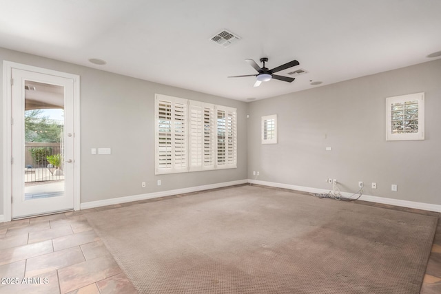 unfurnished room featuring a ceiling fan, baseboards, and tile patterned floors