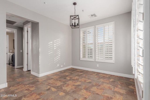 unfurnished dining area featuring a chandelier, visible vents, stone finish floor, and baseboards