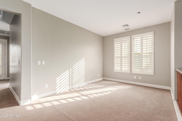 empty room with carpet and baseboards