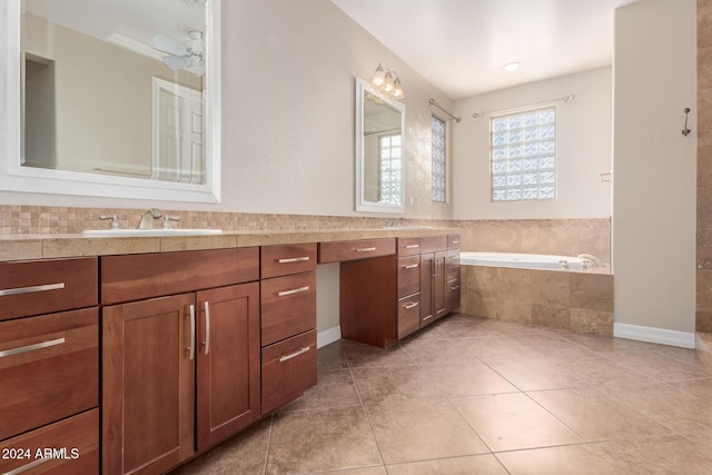 full bath featuring a garden tub, tile patterned flooring, and vanity