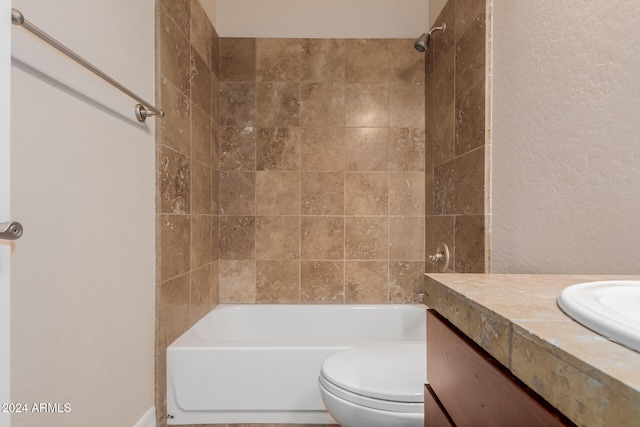 full bathroom featuring tub / shower combination, toilet, vanity, and a textured wall