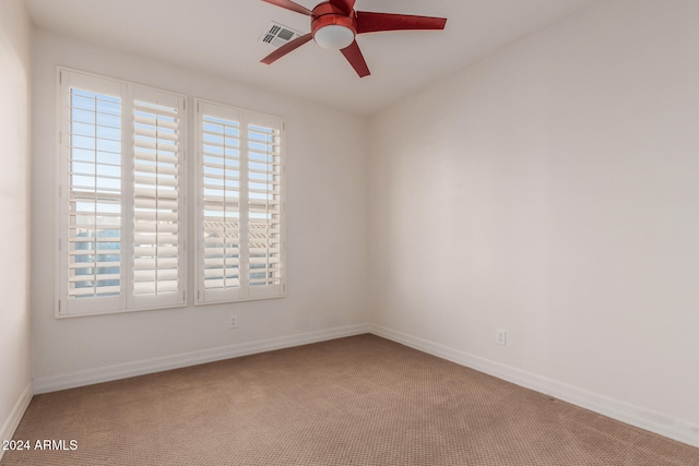 unfurnished room featuring visible vents, ceiling fan, baseboards, and carpet