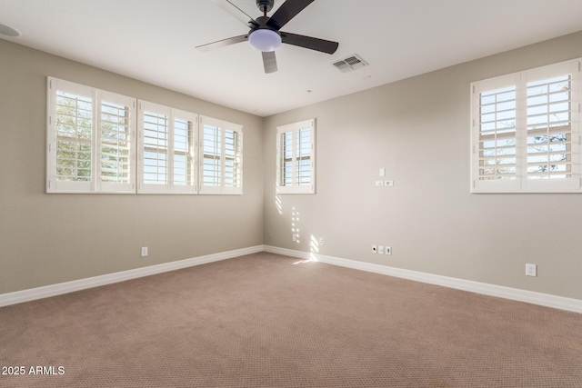 unfurnished room with a ceiling fan, carpet flooring, and baseboards