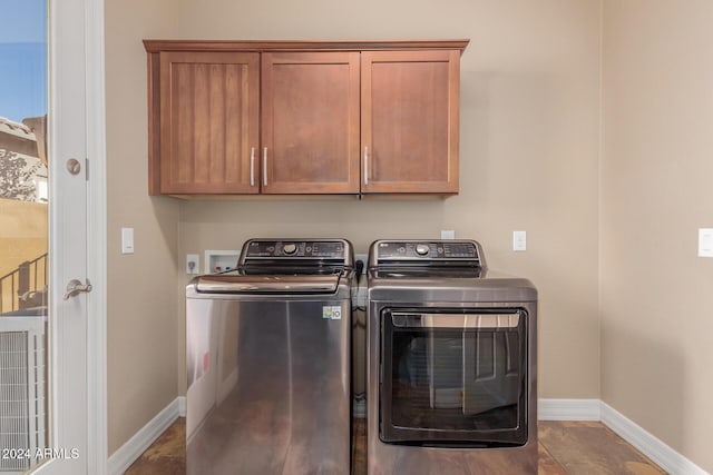 clothes washing area with separate washer and dryer, cabinet space, and baseboards