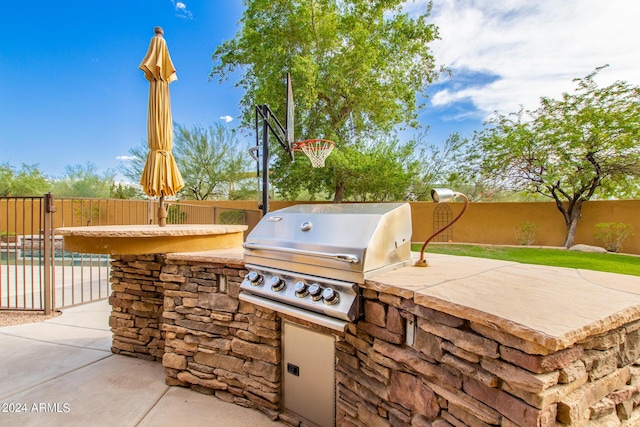 view of patio featuring a grill, a fenced backyard, and area for grilling