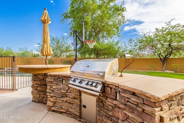 view of patio / terrace with a swimming pool, grilling area, a fenced backyard, and area for grilling