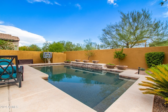 view of swimming pool featuring a patio, a fenced backyard, and a fenced in pool