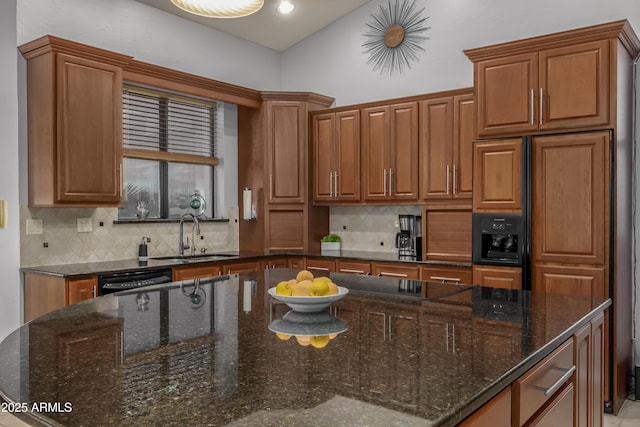 kitchen featuring brown cabinets, a sink, backsplash, and black appliances