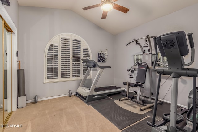 exercise room featuring vaulted ceiling, ceiling fan, and baseboards