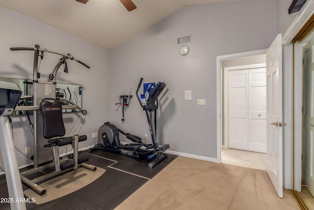 workout area with baseboards, visible vents, vaulted ceiling, and a ceiling fan