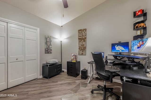 office space featuring lofted ceiling, ceiling fan, baseboards, and wood finished floors