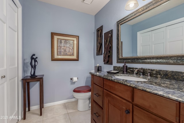 bathroom featuring toilet, baseboards, vanity, and tile patterned floors