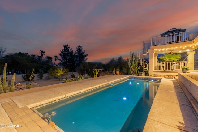 pool at dusk featuring an outdoor pool